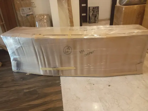Long furniture piece wrapped for transit