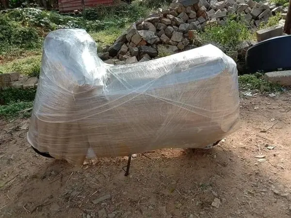 Motorcycle covered with protective sheet for transport